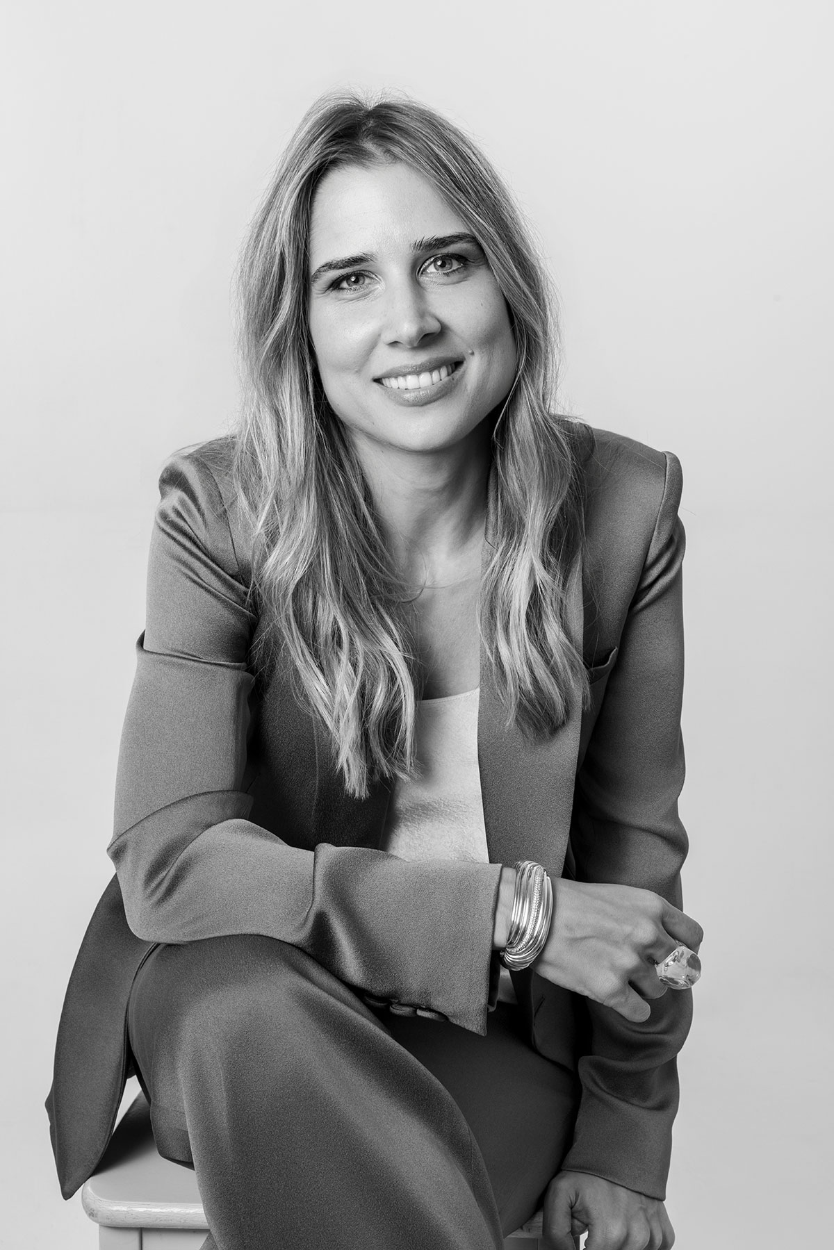 Dr. Irem Gunay, Chartered Psychologist and Existential Psychotherapist, seated and smiling at the camera.